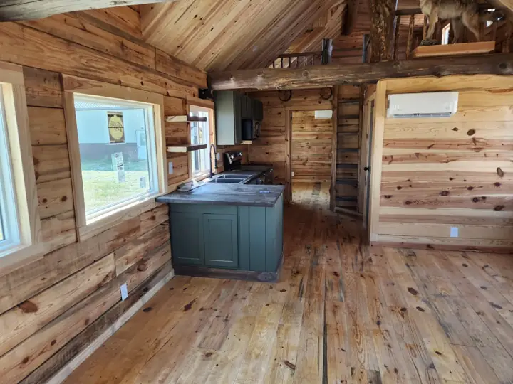 Kitchen and living area under a wood ceiling
