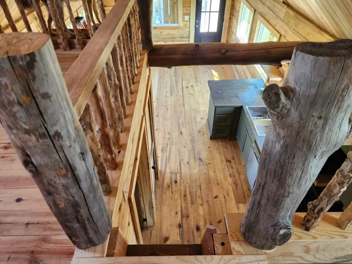 Kitchen and living area seen past log posts